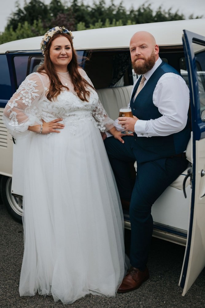 aviary ormskirk wedding bride and groom standing by campervan wedding car