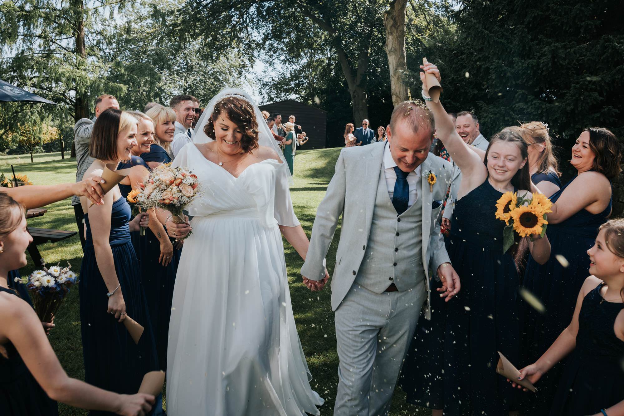 bride and groom getting confetti on heads at losehill house