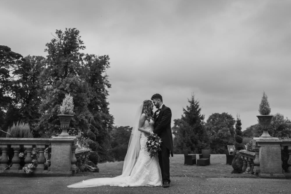 bride and groom posing in gardens at bagden hall