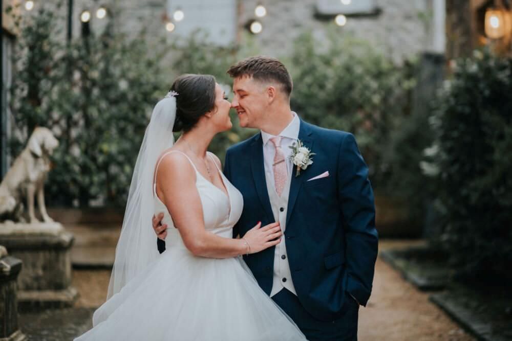 bride and groom rub noses at holmes mill wedding