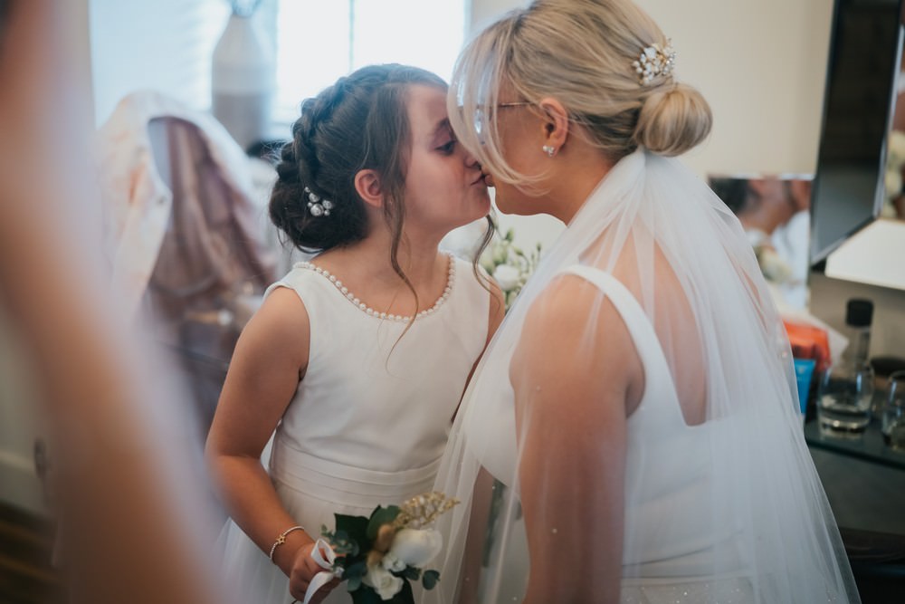 bride kissing flower girl