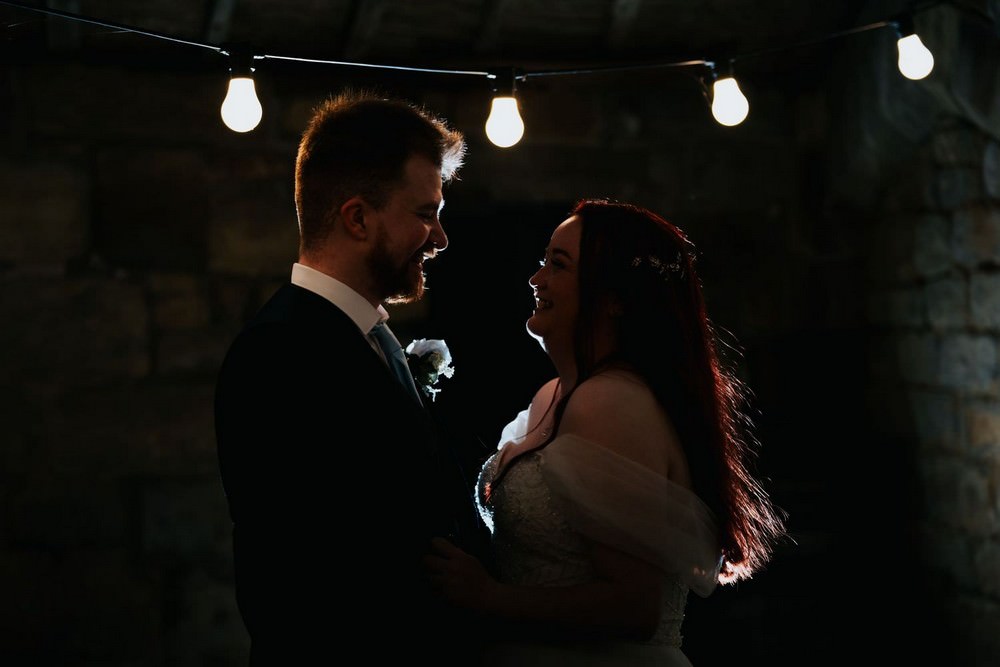 danby castle wedding bride and groom under string lights at night