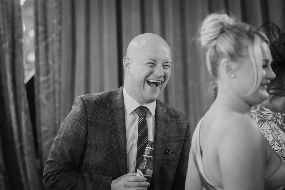 guest at wedding laughing