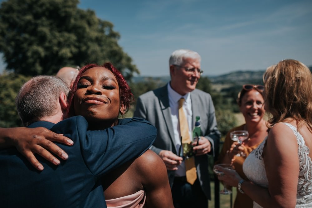 guest hugs groom at shireburn arms wedding