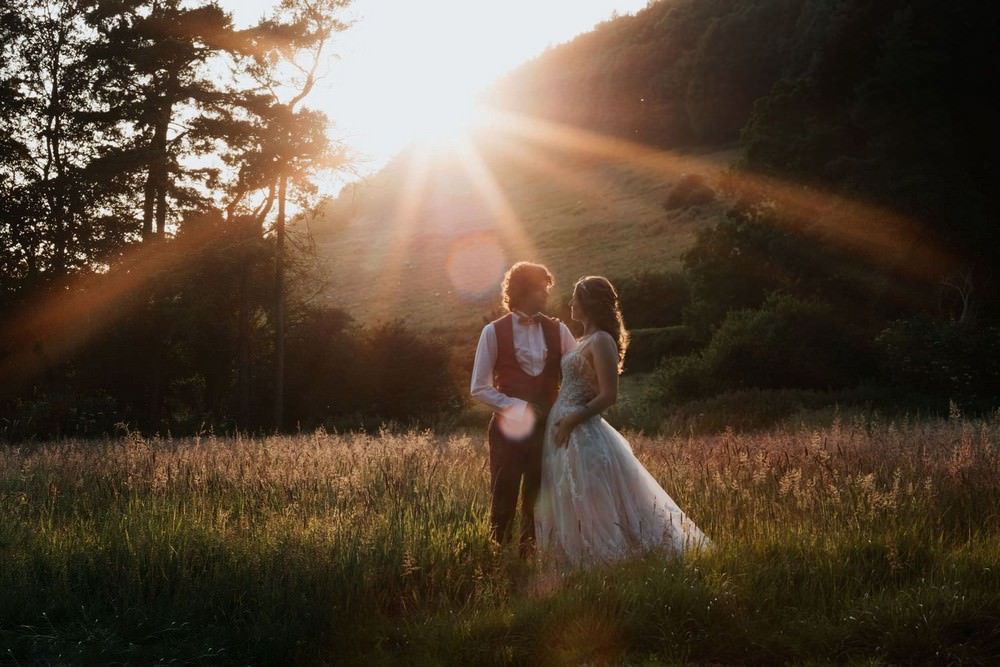 hackness grange wedding bride and groom in field at sunset