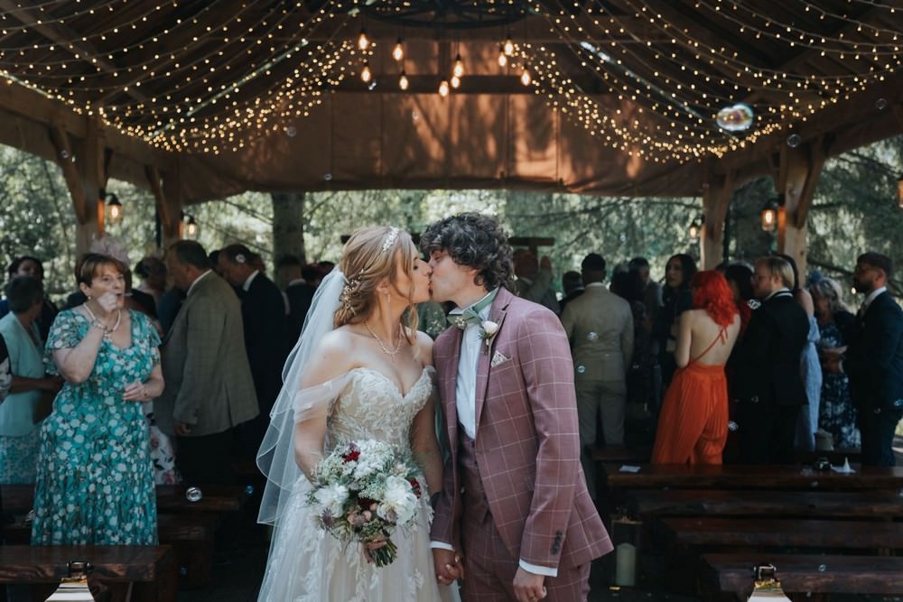 hackness grange wedding bride and groom kiss outside barn on island