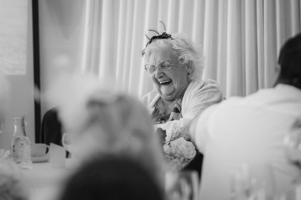 mother of bride laughs during wedding reception at beaches hotel rhyl