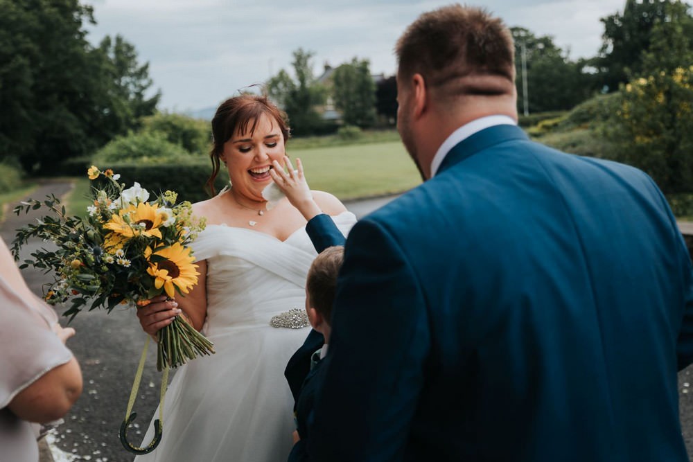 mytton fold wedding page boy tips flowers onto bride