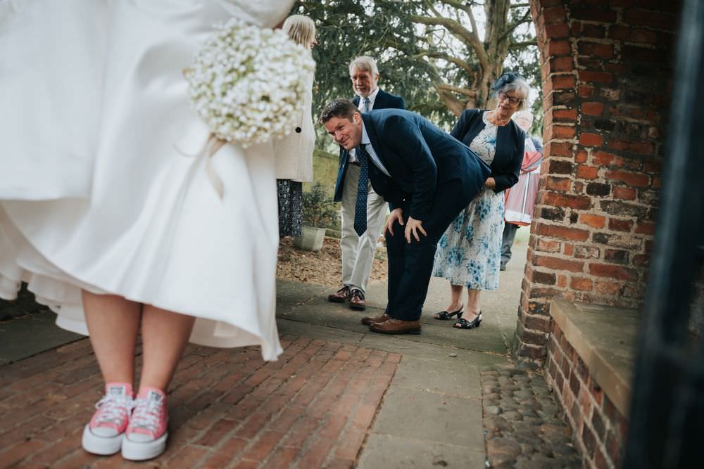 tithe barn poppleton wedding bride shows guests her shoes