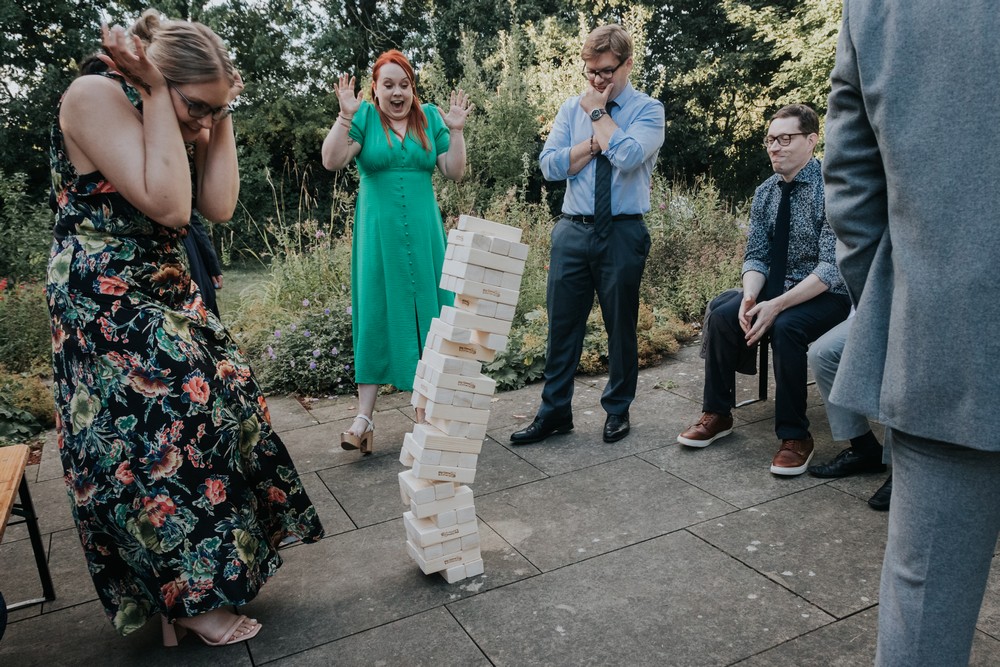 wedding guests playing jenga as bricks fall